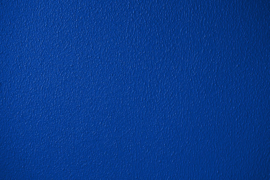 Blue or classic trendy color plaster wall texture detailed close-up
