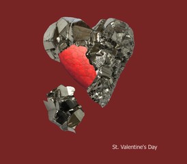 Mineral pyrite in the shape of a heart and red painted heart inside it on a dark red background