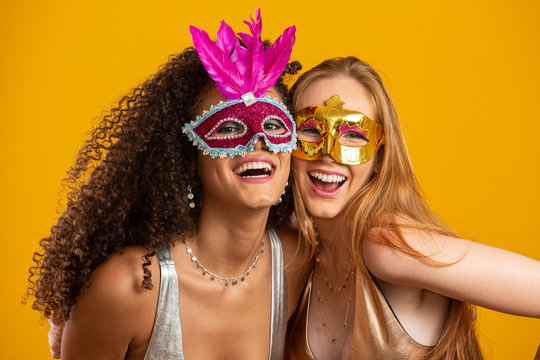 Beautiful women dressed for carnival night. Smiling women ready to enjoy the carnival with a colorful mask. - Powered by Adobe