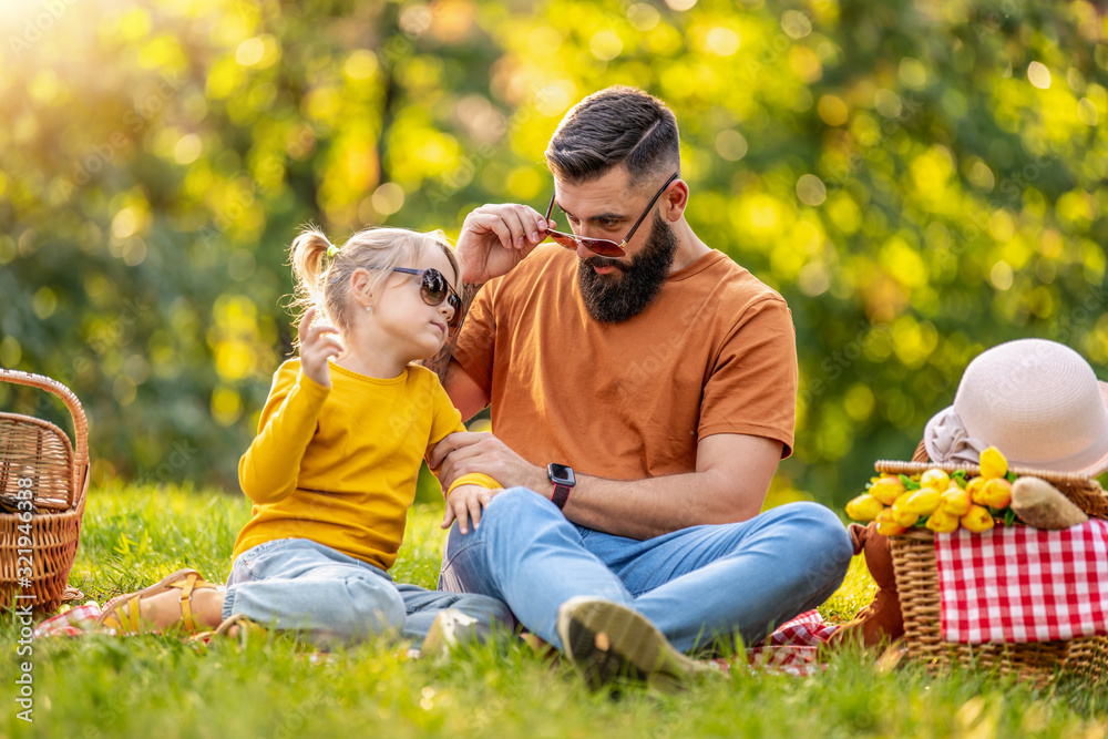 Wall mural joyful family picnicking in summer park