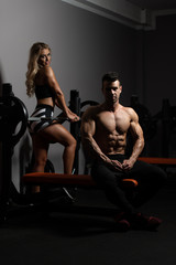 Fototapeta na wymiar Fit Couple Together Training Chest With Weights