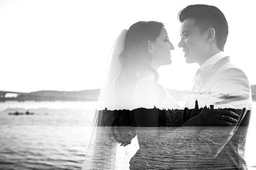 Multi exposure. Happy newlyweds look at each other with love and hugging. Black and white photo