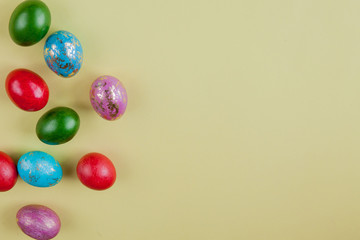 Colorful Easter egg side border over a yellow paper background