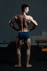 Fototapeta na wymiar Young Bodybuilder Flexing Back Pose