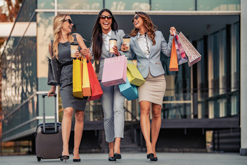 Portrait of smiling businesswomen with shopping bags