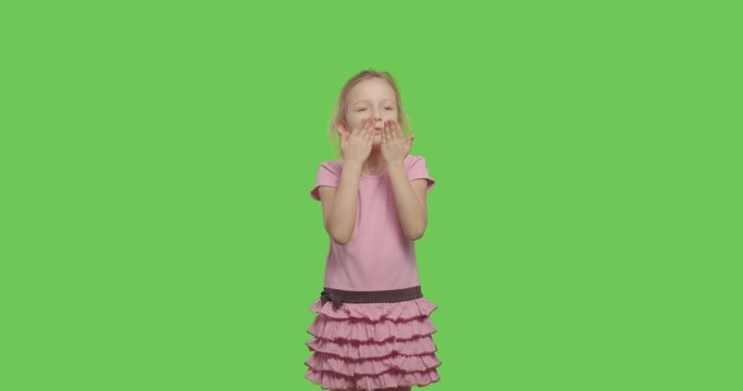 Child blowing and sending air kisses