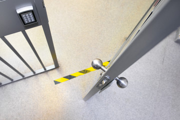 Metal bars in prison. Opened jail cell door. The lock an steel bobble handle closeup . Safety line. Do not cross!
