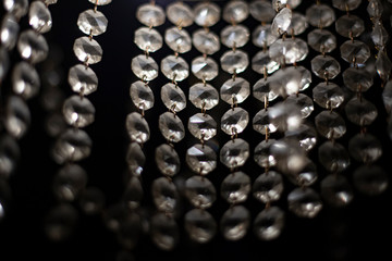 Glass elements transmit light from lamps. A chandelier spreads light through repeating wands. Cold...