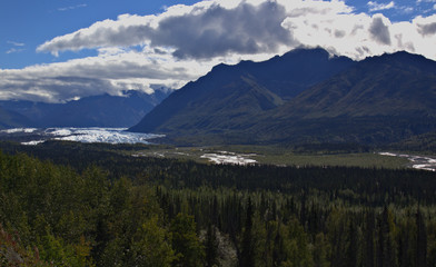 Alaskan Glacier in the distance under the cloudy sky