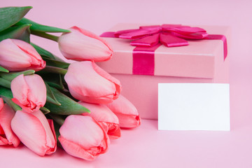 Gift with flowers tulips on a pink background for Valentine's Day, for Mother's Day, mock up