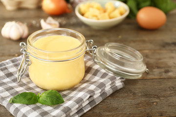 Jar with tasty sauce on table
