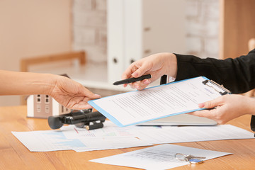 Real estate agent working with client in office