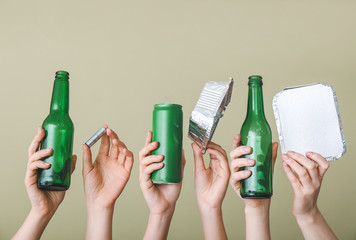 Hands with garbage on color background. Concept of recycling