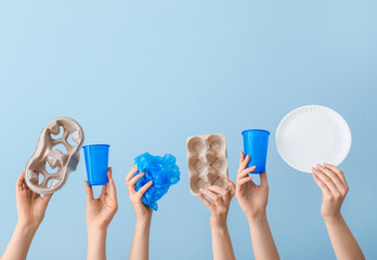 Hands with garbage on color background. Concept of recycling