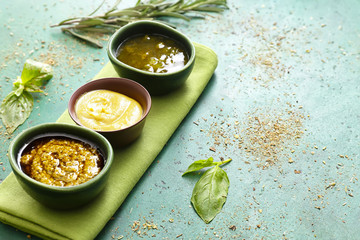 Different tasty sauces on color background