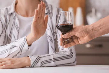 Foto op Plexiglas Woman refusing to drink wine at home. Concept of alcoholism © Pixel-Shot