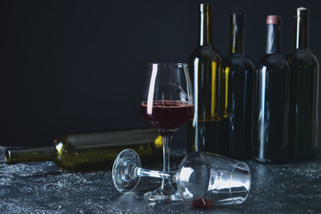 Glasses and bottles and wine on table. Concept of alcoholism