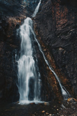 large waterfall running down rocks