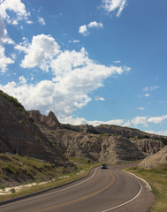 car driving down curving road