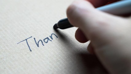 Hand writing thank you note on brown color paper