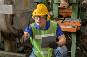 Male asain inspector, engineer working  in the production line process at industry