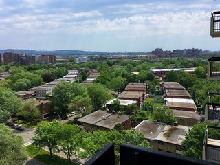 Fototapeta premium A cityscape of Montreal with a view on the Mount Royal mountain and the suburban area of Ville Saint Laurent with residential neighborhood duplexes and greenery.