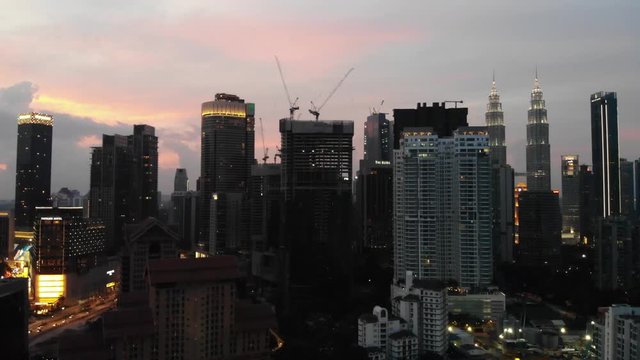 rosey sunset aerial landing over downtown skyline