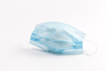 A close-up shot of a disposable surgical mask