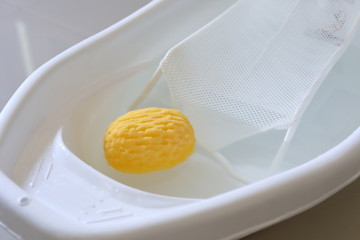 baby bathtub with support seat of newborn sitting in water and soft sponge