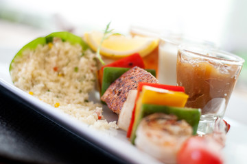 Grilled salmon in BBQ seafood skewer on white plate eat with quinoa