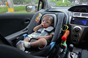 cute baby boy excited sitting on car seat safety drive road trip travel