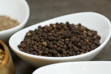 Close up of  whole Black pepper in a bowl