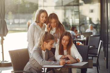 Students in a park. Girls on a campus. Friends sitting at the table.