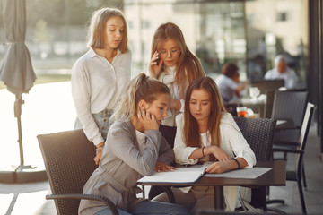 Students in a park. Girls on a campus. Friends sitting at the table.