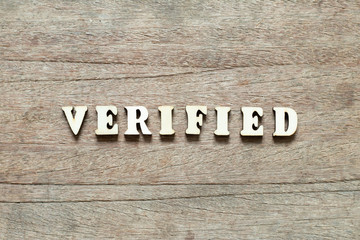 Letter block in word verified on wood background