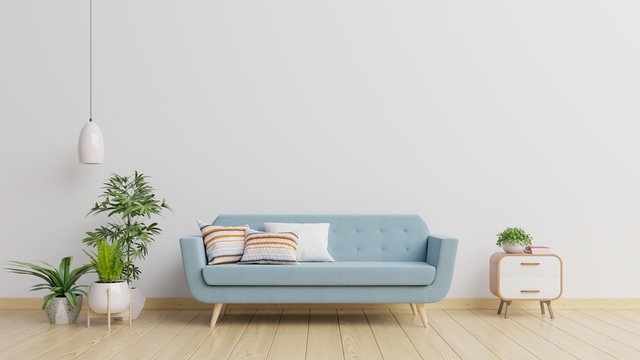 Modern living room interior with sofa and green plants,lamp,table on white wall background.