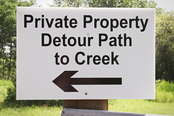 A private property detour path to creek sign