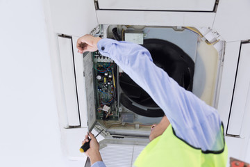 Technician is checking air conditioner.
