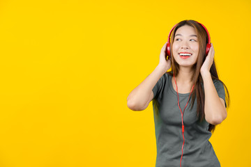 Happiness Asian smiling young woman wearing technology wireless headphones for listening the music...