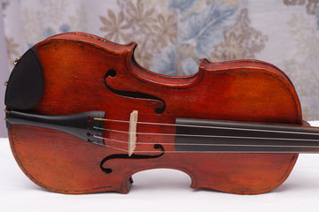 Broken antique red violin for restoration with damage