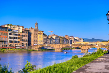 Fototapeta na wymiar A view of the Arno River towards the Ponte Vecchio in Florence, Italy.