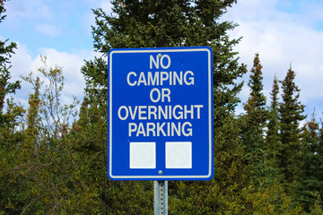 A no camping or overnight parking sign
