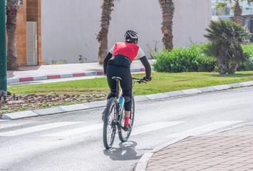 Unidentified cyclist riding his bicycle on road