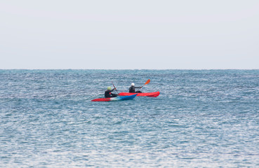 A pair of kayakers in the sea as an emphasis point