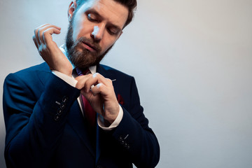 Man in suit adjusting sleeve on his suit 
