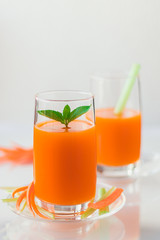 Freshly squeezed carrot juice with celery, vertical orientation