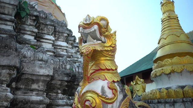 Amazing Golden Chinthe near old Chedi in a traditional Buddhist Temple in Chiang Mai, Thailand.