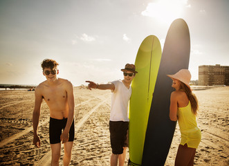Friends on the beach with surf boards 