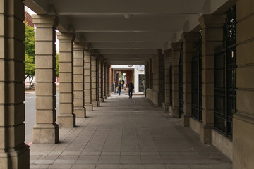 Exterior hallway with brown walls at the center of perspective
