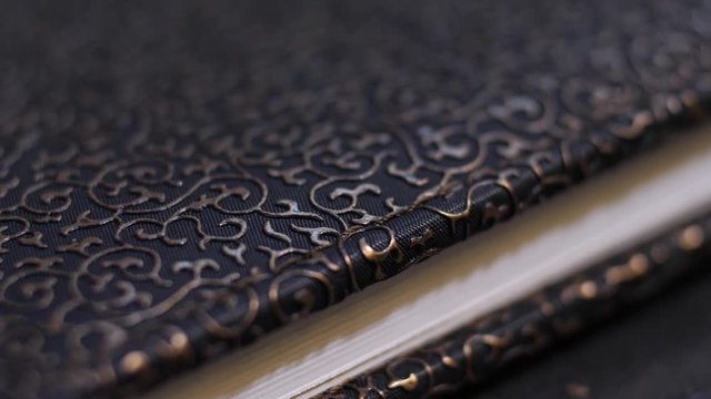 cover of an old leather book with a golden pattern macro